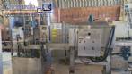 Labeling machine with steam sleeve tunnel and bottle baler