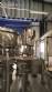 Zegla rotary filling machine with rinser and three-block capping system.