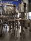 Zegla rotary filling machine with rinser and three-block capping system.