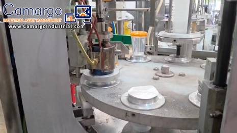 Rotary filling and dosing machine with capping and sealing unit for cups and bottles, capacity 2,000 units.