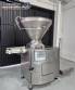 Handtmann vacuum stuffer with twister and tilting elevator, up to 6,000 kg per hour.
